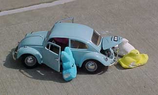 Photo of Peeps exiting a small VW Beetle
