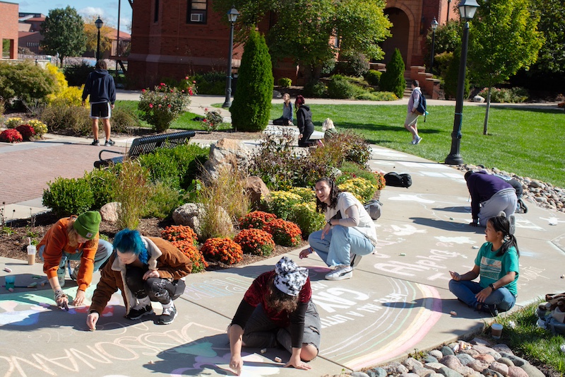 students chalking the sidewalk