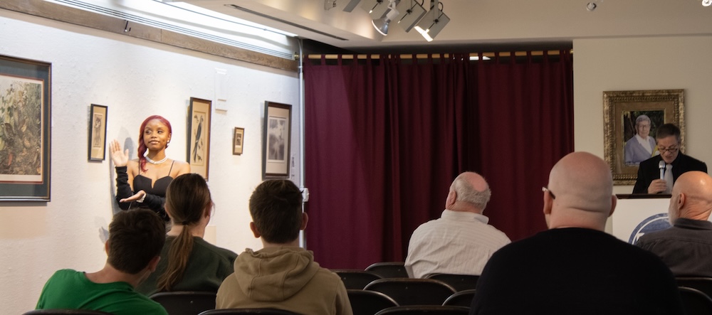 People sitting at auction for artwork