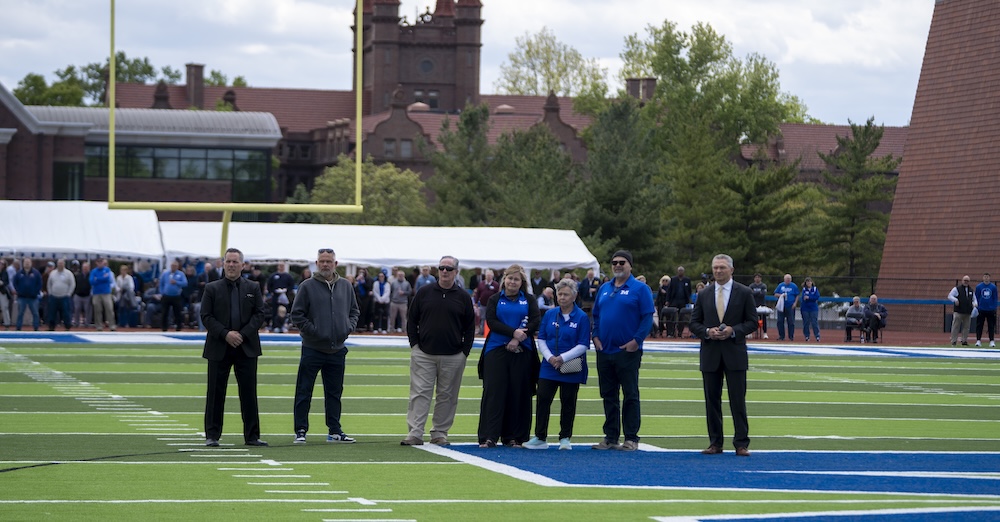 people standing on football field