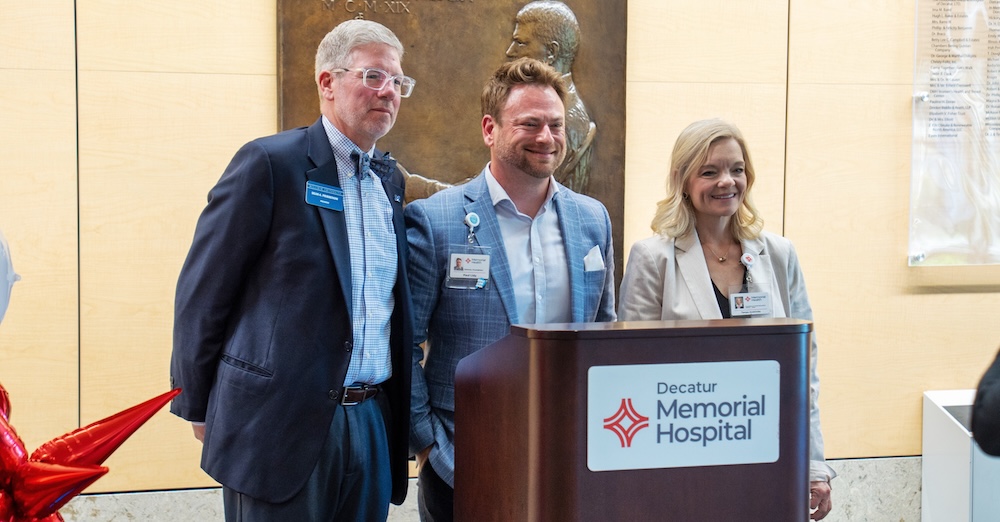 3 people standing at a podium