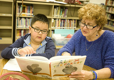 Teacher reading to student