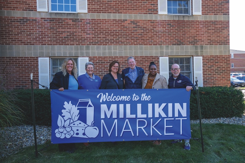 people standing in front of millikin market