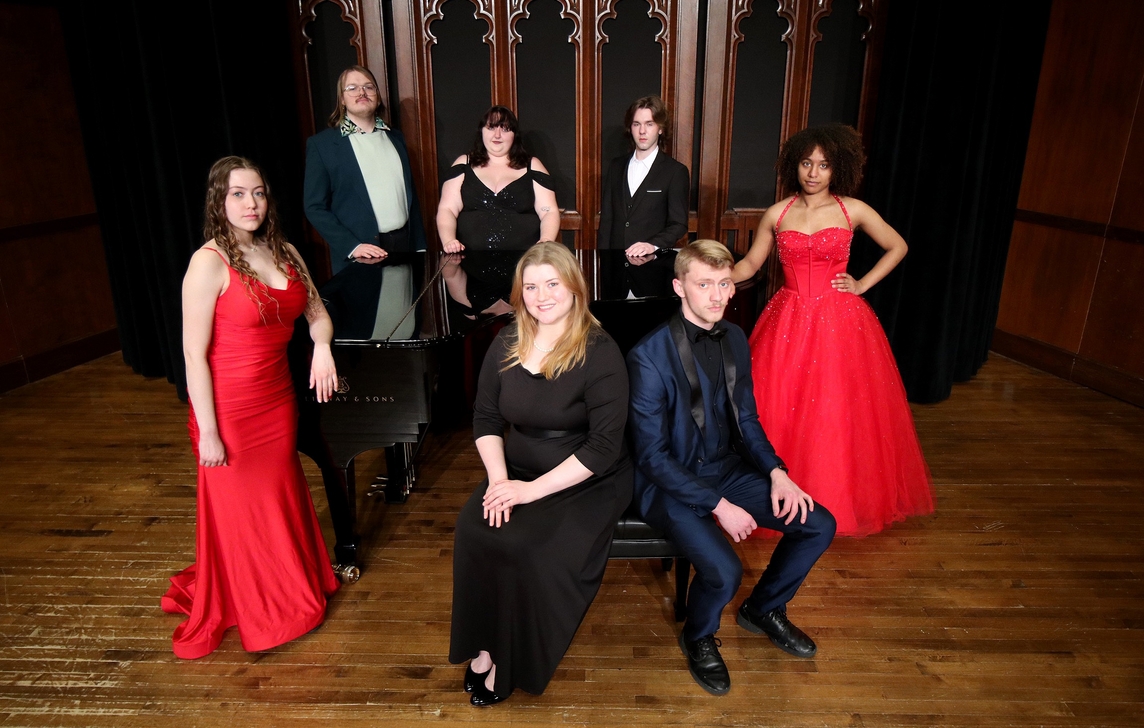 Student members of the Millikin Opera Gala pose on the stage of Kaeuper Hall