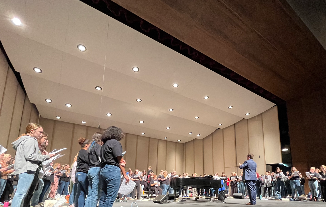 Ben Hawkinson directs the Vocal Fest choir on the Kirkland stage.