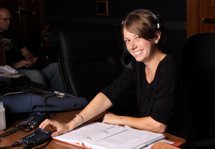 Student smiling wearing a headset