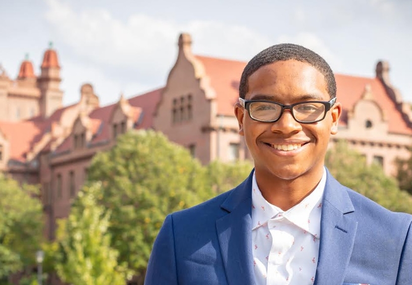 person standing with shilling hall in background