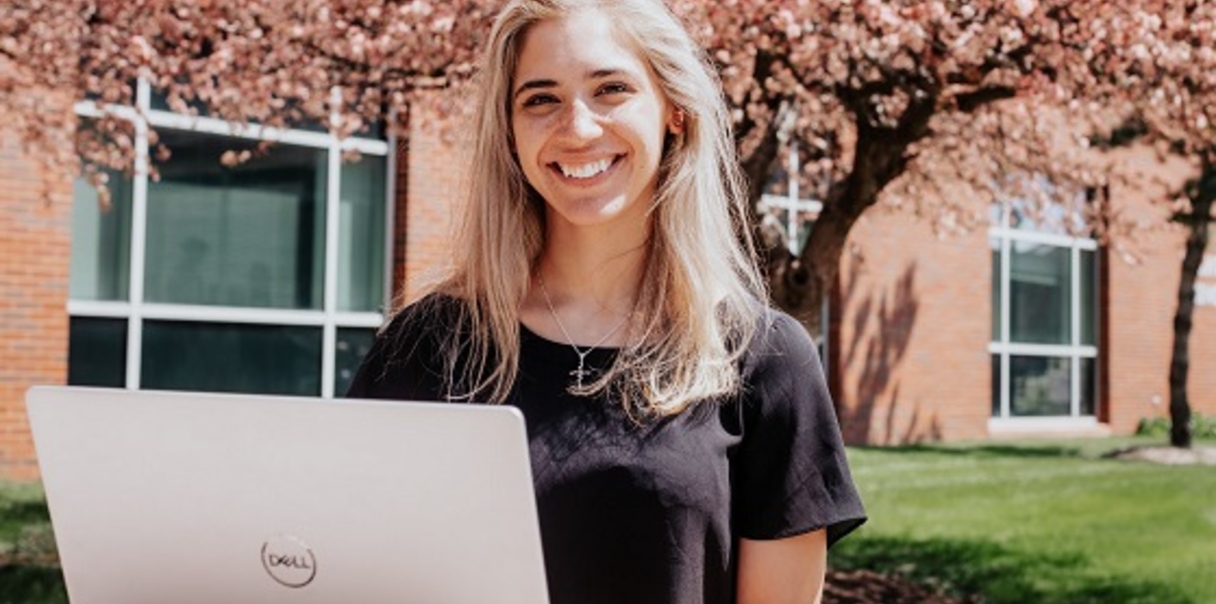 Student smiling with laptop