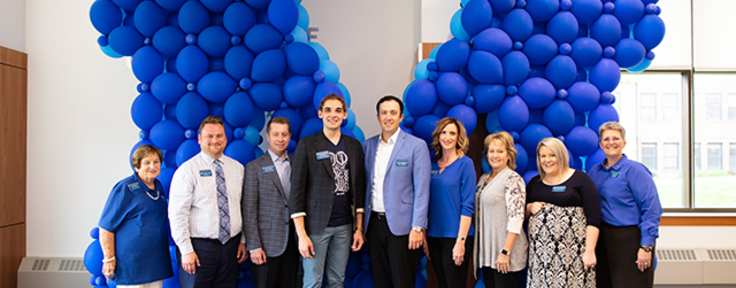 people standing in front of balloons 