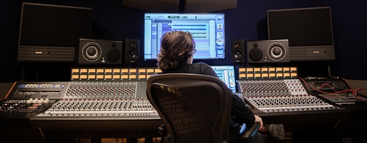 Student sitting at sound board