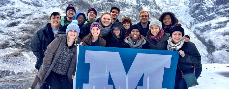 Students holding up a Millikin flag