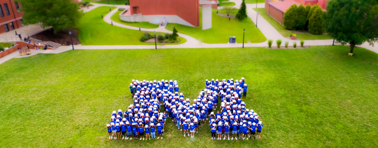 Students forming an M on quad