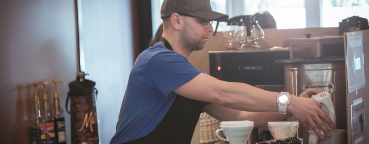 worker brewing coffee