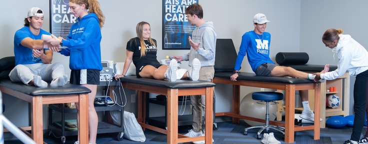 Athletics science students practicing skills
