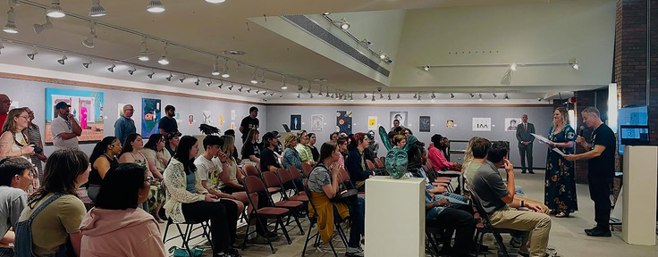 Group of people sitting in front of speakers