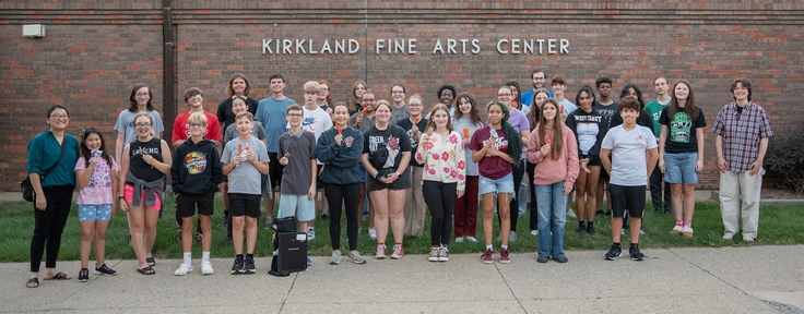 students gathered in front of kirkland fine arts center