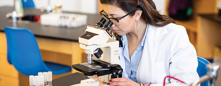 Student looking in microscope