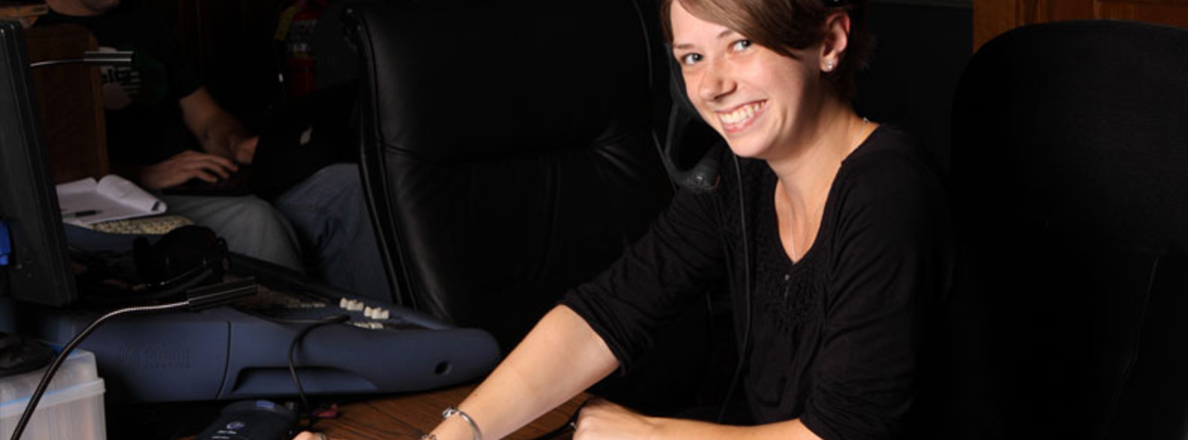Student smiling wearing a headset