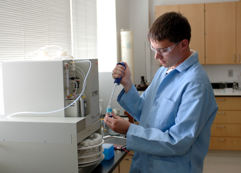 Student with lab equipment