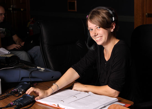 Student smiling wearing a headset