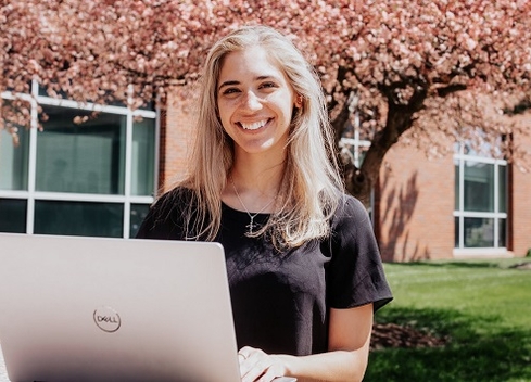 Student smiling with laptop