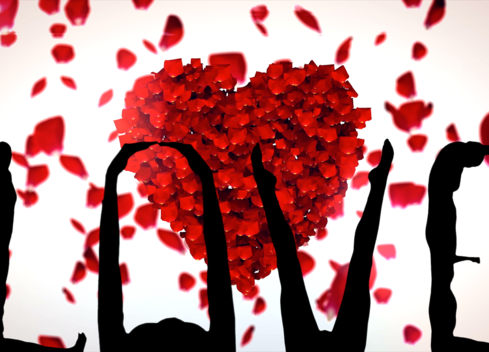 Background shows a heart made of flower petals. In the foreground, people contort their bodies in silhouette to spell LOVE.