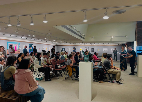 Group of people sitting in front of speakers