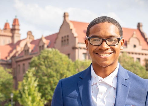 person standing with shilling hall in background