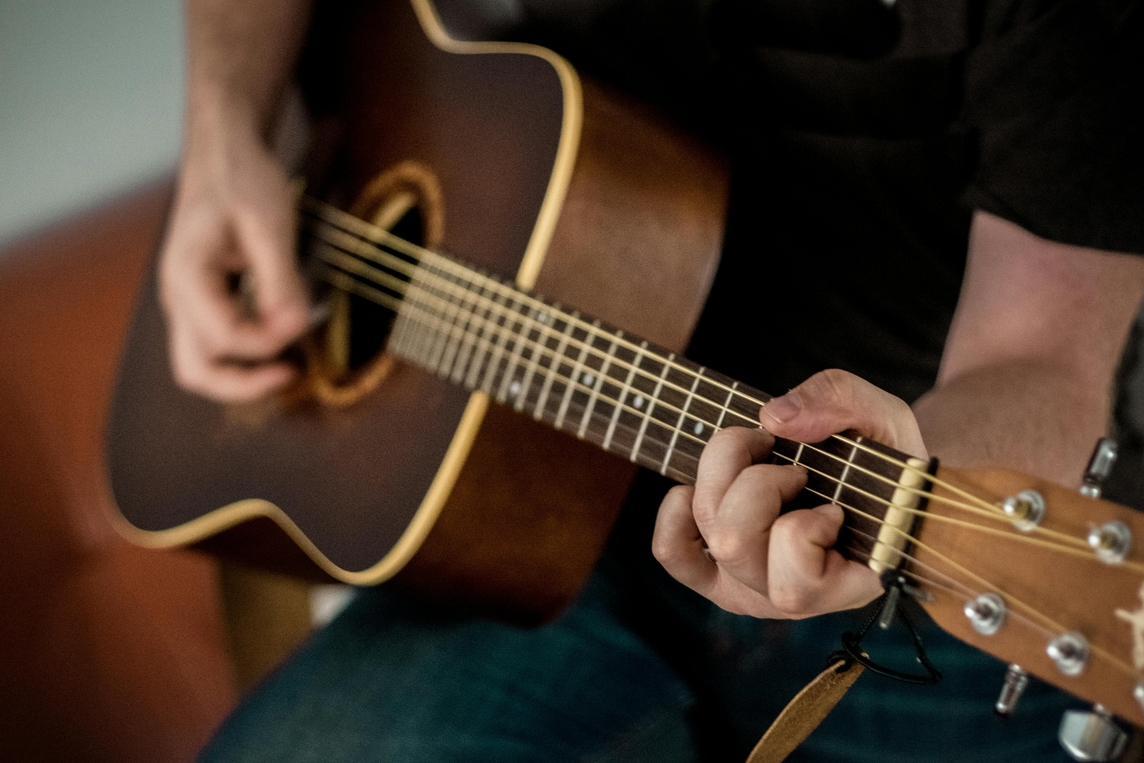 Close up of a man playing guitar. 