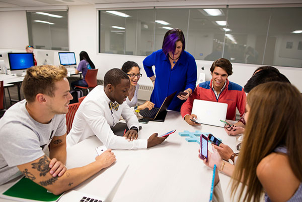 Digital media marketing students work on phones