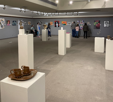 An exhibition of student work, including ceramics on pedestals at the Perkinson Gallery in Kirkland Fine Arts Center.