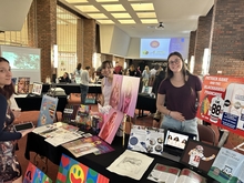 Student displays their work in the lobby of Kirkland Fine Arts Center