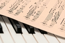 Piano keyboard with sheet music.